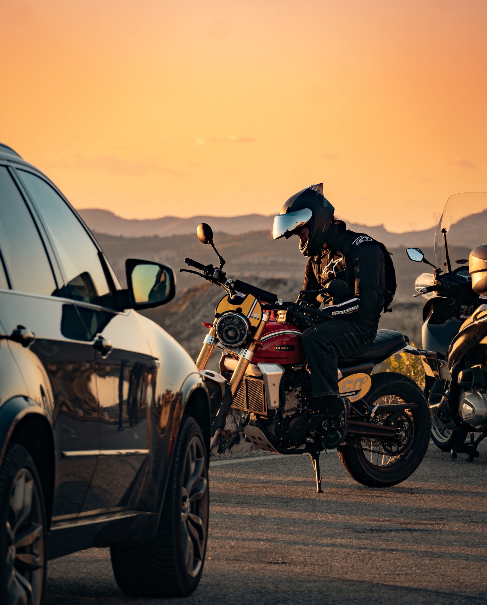 motard au coucher de soleil avec sa moto